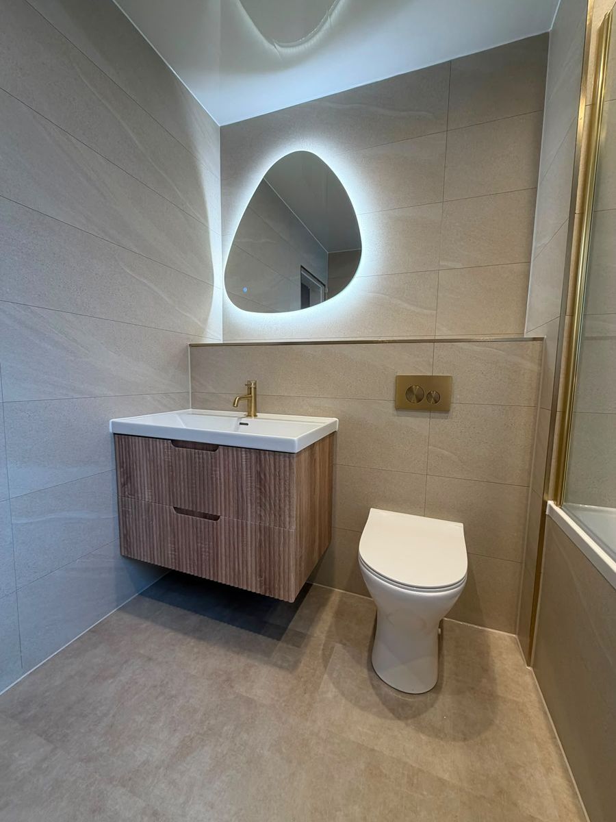 Compact en-suite shower room with walnut vanity and stone basin